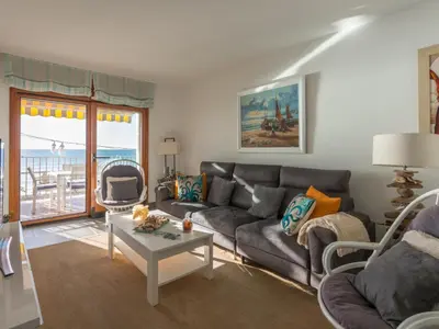 a living room with a couch and a table at Apartamento cómodo frente al mar con acceso directo a la playa - ES-332-6 in Vilanova i la Geltrú