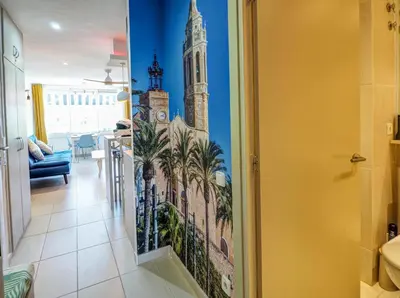 a bathroom with a wall mural of a clock tower at Balcis Apartment by Hello Homes Sitges in Sitges