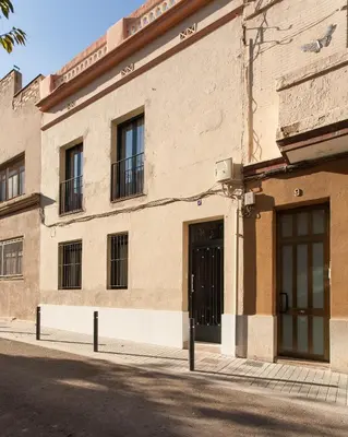 a brick building with two doors on a street at Key San Pau House Terrace - Barcelona in Barcelona