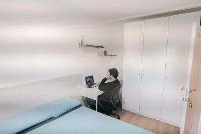 a person sitting at a desk with a computer at Cotonat in El Arrabal