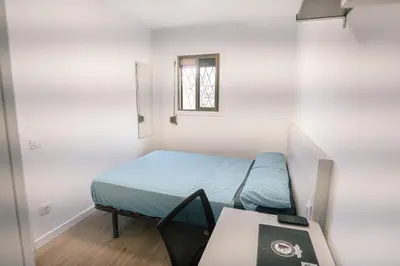 a small room with a bed and a table at Cotonat in El Arrabal