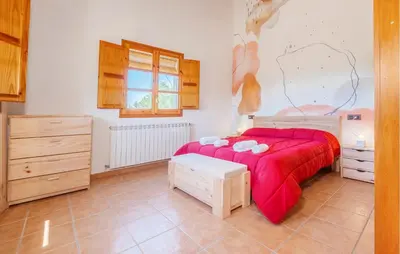 a bedroom with a bed with a red blanket at Beautiful Home In Guardiola De Fontrubí in La Guardiola
