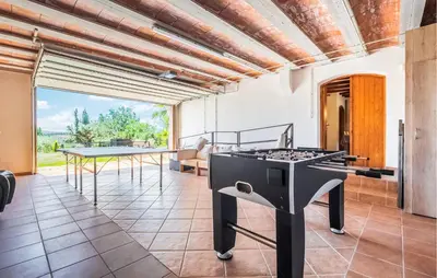 a kitchen with a grill and a ping pong table at Beautiful Home In Guardiola De Fontrubí in La Guardiola