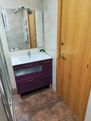 a bathroom with a sink and a mirror at Apart Granollers Centre in Granollers