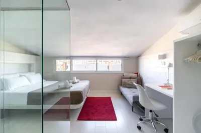 a bedroom with a bed and a desk and a couch at Penthouse with private terrace in the center in Barcelona
