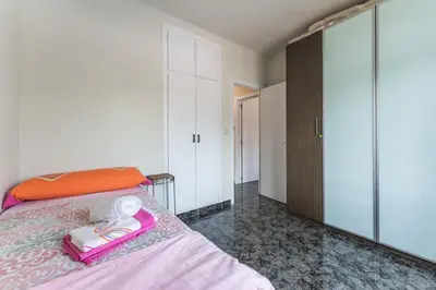 a bedroom with a bed and a large closet at Casa de vacances Mary in Santa Eulalia de Ronsaná