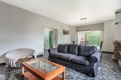 a living room with a couch and a table at Casa de vacances Mary in Santa Eulalia de Ronsaná