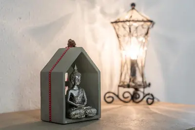 a small box sitting on a table with a statue at Casa de vacances Mary in Santa Eulalia de Ronsaná