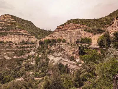 a view of a mountain with trees and buildings on it at AranEtxea in Bigues i Riells