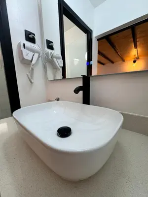 a white sink in a bathroom with a mirror at Apart con terraza en Florida E2 in Hospitalet de Llobregat