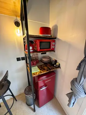 a small kitchen with a red microwave in a room at Apart con terraza en Florida E2 in Hospitalet de Llobregat
