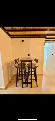 a wooden table and chairs in a room at Apart con terraza en Florida E2 in Hospitalet de Llobregat