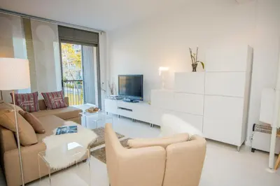 a living room with a couch and a tv at Opening Doors Pueblonuevo in Barcelona