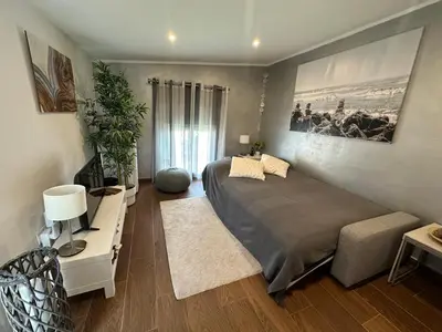 a bedroom with a large bed and a desk with a lamp at Casa Salud in Piera