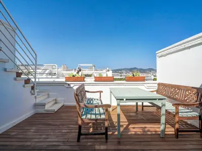 a patio with a table and chairs on a balcony at Panoramic Terraces by Hello Homes Sitges in Sitges
