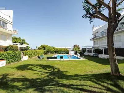 a yard with a swimming pool and a tree at Panoramic Terraces by Hello Homes Sitges in Sitges