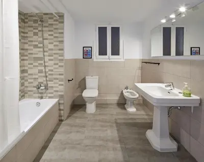 a bathroom with a sink and a toilet and a tub at Girona 46 - 1 in Barcelona