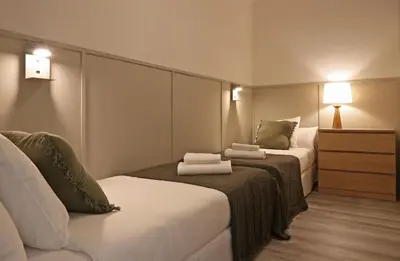 a hotel room with two beds with towels on them at Sagrada Familia - The Haus Bcn in Barcelona