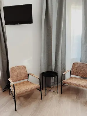 two chairs and a tv in a room at Apartamentos Express by gaiarooms in Barcelona