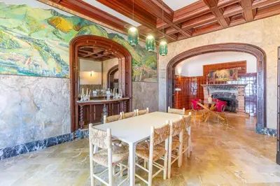 a dining room with a table and a mural at Casa Mas Blau | Increíbles vistas frente al mar in San Pol de Mar