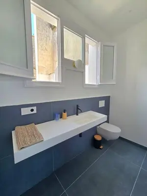 a bathroom with a sink and a toilet at Casa Mas Blau | Increíbles vistas frente al mar in San Pol de Mar