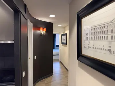 a hallway with a framed picture of a building at Stay U-nique Apartment Putxet II in Barcelona