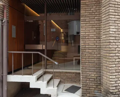 a brick building with stairs in front of a door at Stay U-nique Apartment Putxet II in Barcelona