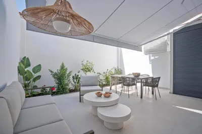 a living room with a couch and a table at Sitges Spaces Garden Condo-2 Bedrooms, 2 Bathrooms, Garden Terrace, Near center, Sleeps up to 6- Monthly Rentals Only in Sitges