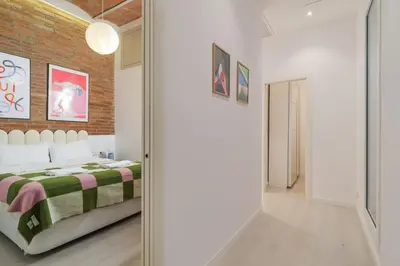a bedroom with a bed and a brick wall at GuestReady - Lovely home in the heart of Barcelona in Barcelona