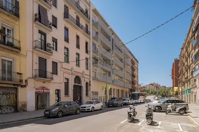 a city street with cars and motorcycles parked on the street at GuestReady - Lovely home in the heart of Barcelona in Barcelona