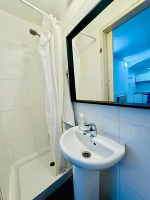 a bathroom with a sink and a mirror and a shower at O43 Center Barça 4 3 in Barcelona