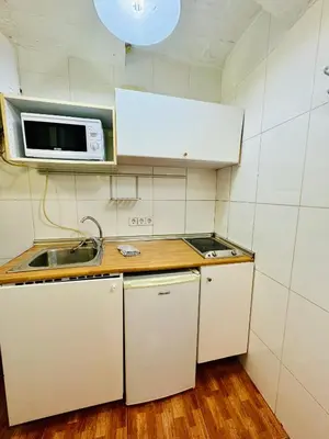 a small kitchen with a sink and a microwave at O43 Center Barça 4 3 in Barcelona