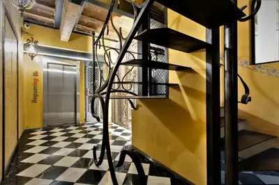 a hallway with a black and white checkered floor at Barcelona Classic Palau Apartments in Barcelona