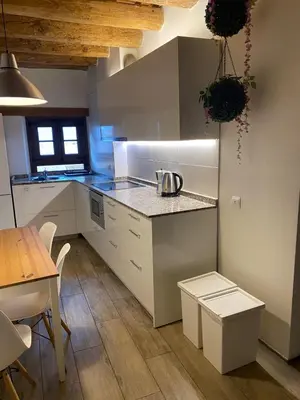 a kitchen with white cabinets and a table and a table and a table at Barcelona Classic Palau Apartments in Barcelona