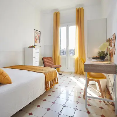 a bedroom with a bed and a desk at Gran Via - 1 in Barcelona