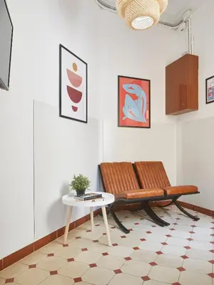 a living room with a bench and a table at Gran Via - 1 in Barcelona
