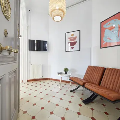 a living room with a couch and a table at Gran Via - 1 in Barcelona