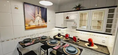 a kitchen with a table with red dishes on it at Apartamento exclusivo junto Sagrada Familia Barcelona in Barcelona