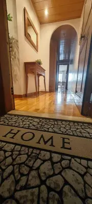 a hallway with a welcome mat on the floor of a house at Apartamento exclusivo junto Sagrada Familia Barcelona in Barcelona
