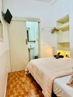 a bedroom with a bed and a tv on the wall at 033 Basic Barça 3 3 in Barcelona