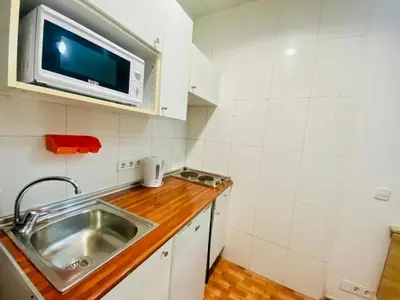 a kitchen with a sink and a microwave at 033 Basic Barça 3 3 in Barcelona