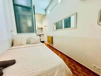 a bedroom with two beds and a window at 033 Basic Barça 3 3 in Barcelona