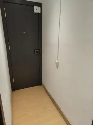 a room with a black door and a wooden floor at 033 Basic Barça 3 3 in Barcelona