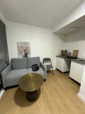 a living room with a couch and a table at alquilo mini departamento in Sant Boi del Llobregat