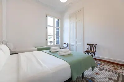 a white bedroom with a bed with towels on it at BP2 - Big apartment for groups in BCN city center HUTB - 77390 in Barcelona