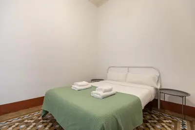a bedroom with a bed and a table with towels at BP2 - Big apartment for groups in BCN city center HUTB - 77390 in Barcelona