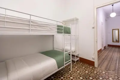 a bedroom with two bunk beds and a hallway at BP2 - Big apartment for groups in BCN city center HUTB - 77390 in Barcelona