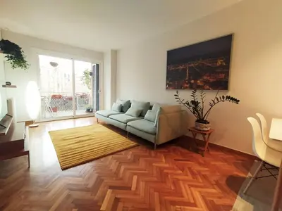 a living room with a couch and a rug at Spacious apartment in the heart of the city in Barcelona
