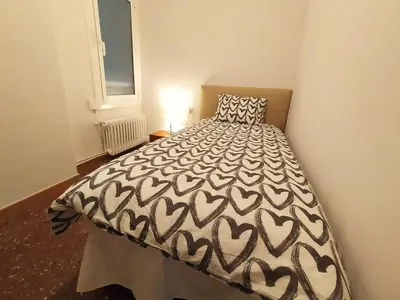 a bedroom with a bed with a black and white bedspread at Spacious apartment in the heart of the city in Barcelona