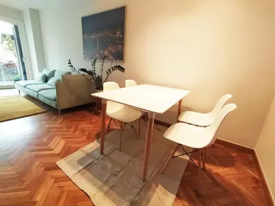 a dining room with a white table and white chairs at Spacious apartment in the heart of the city in Barcelona